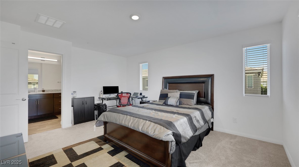 12346 Indigo Montage Road, Unit 4 Las Vegas, NV 89183 - Photo 18 of 27 Bedroom featuring light carpet, multiple windows, recessed lighting, and a desk
