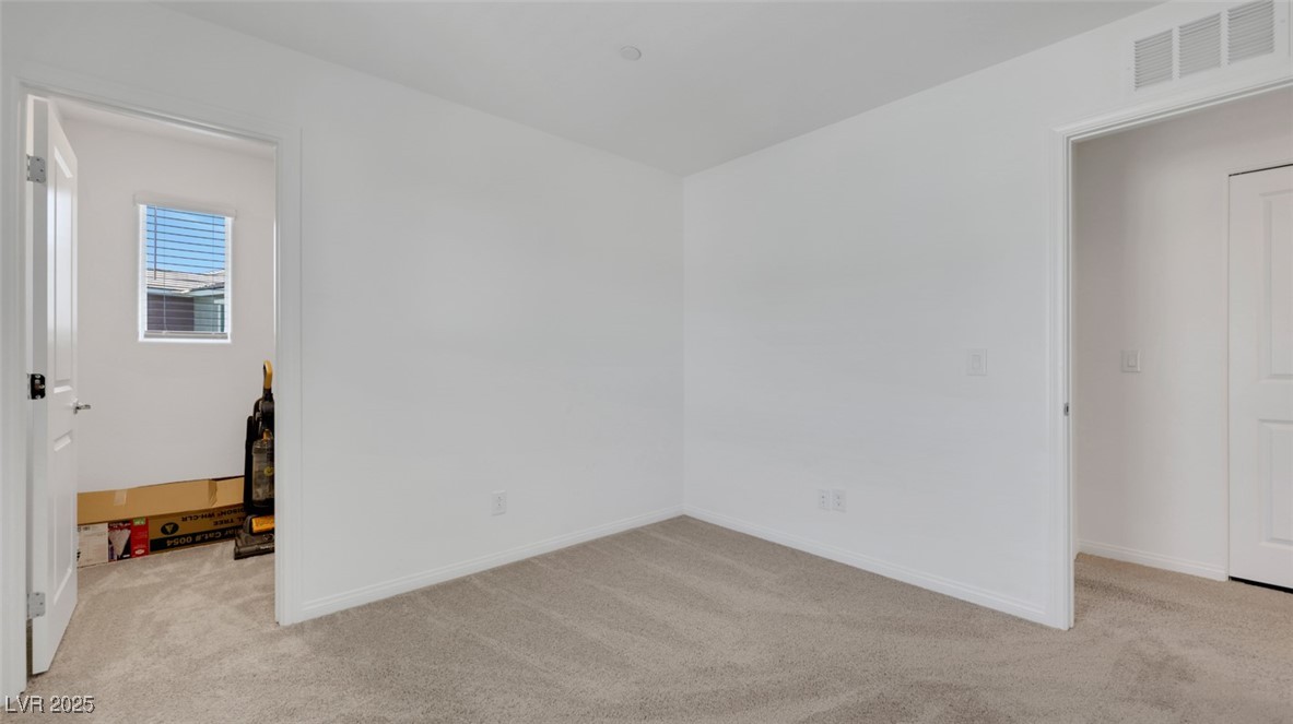 12346 Indigo Montage Road, Unit 4 Las Vegas, NV 89183 - Photo 23 of 27 Empty room featuring carpet floors and baseboards
