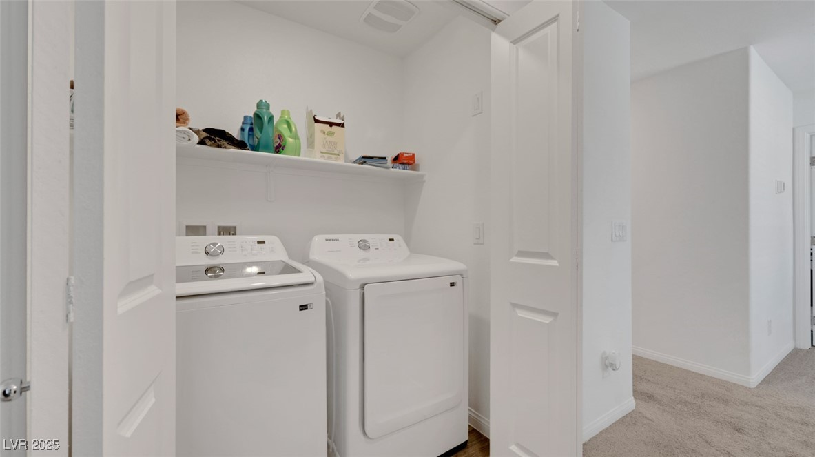 12346 Indigo Montage Road, Unit 4 Las Vegas, NV 89183 - Photo 26 of 27 Laundry room featuring washing machine and dryer and light colored carpet