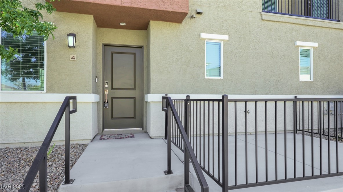 12346 Indigo Montage Road, Unit 4 Las Vegas, NV 89183 - Photo 4 of 27 Doorway to property with stucco siding