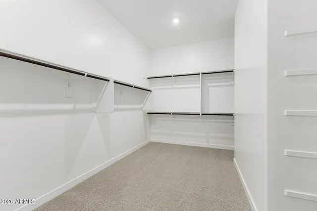 a bathroom with a double vanity sink a toilet and shower