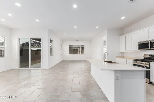 a large kitchen with lots of counter space and furniture