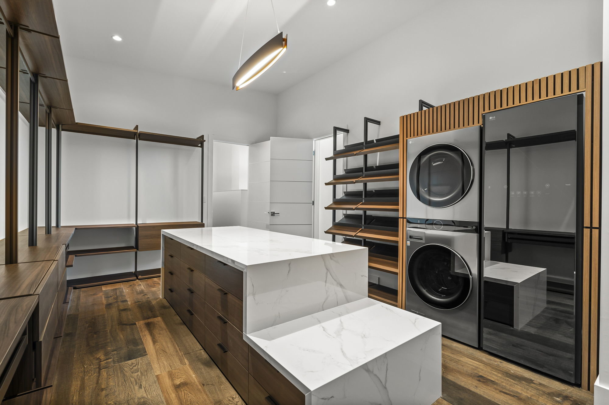 1702 Moonlight Trace Spicewood, TX 78669 - Photo 29 of 40 Walk in closet with dark wood-style flooring and stacked washer / dryer