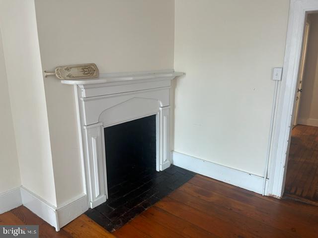 105 Cumberland Street, Unit 3 Clear Spring, MD 21722 - Photo 7 of 11 a view of an empty room with wooden floor and a fireplace