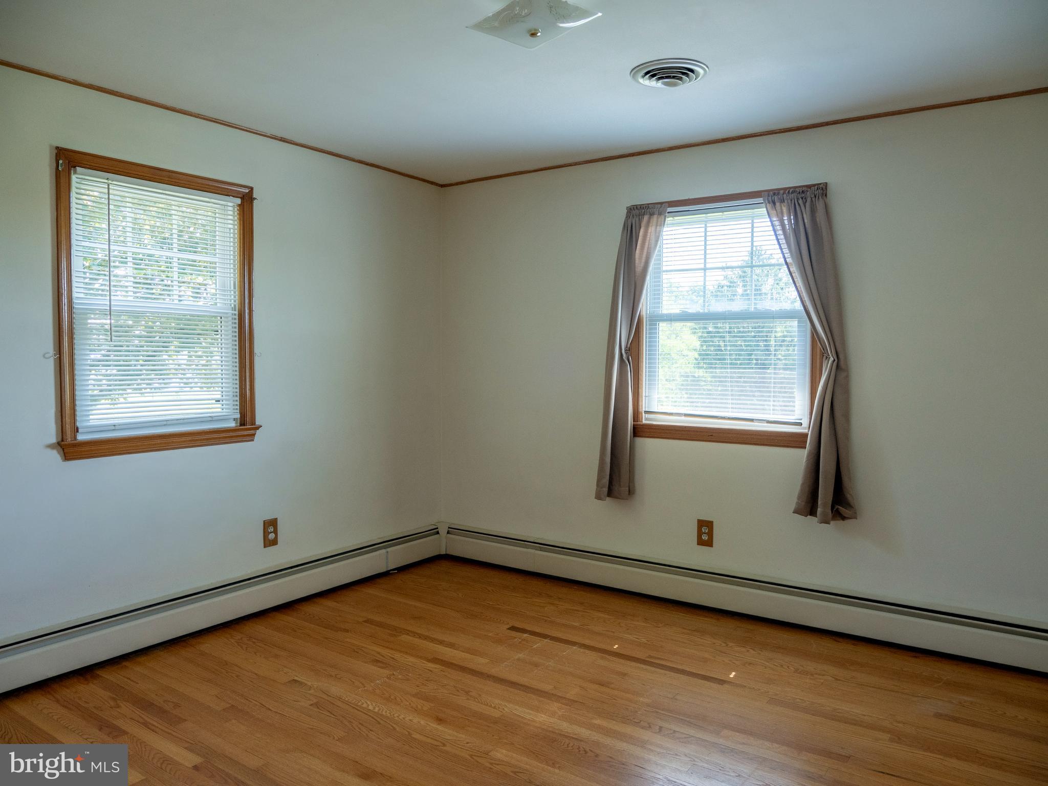 26906 Clarksburg Road Damascus, MD 20872 - Photo 11 of 17 an empty room with wooden floor and windows