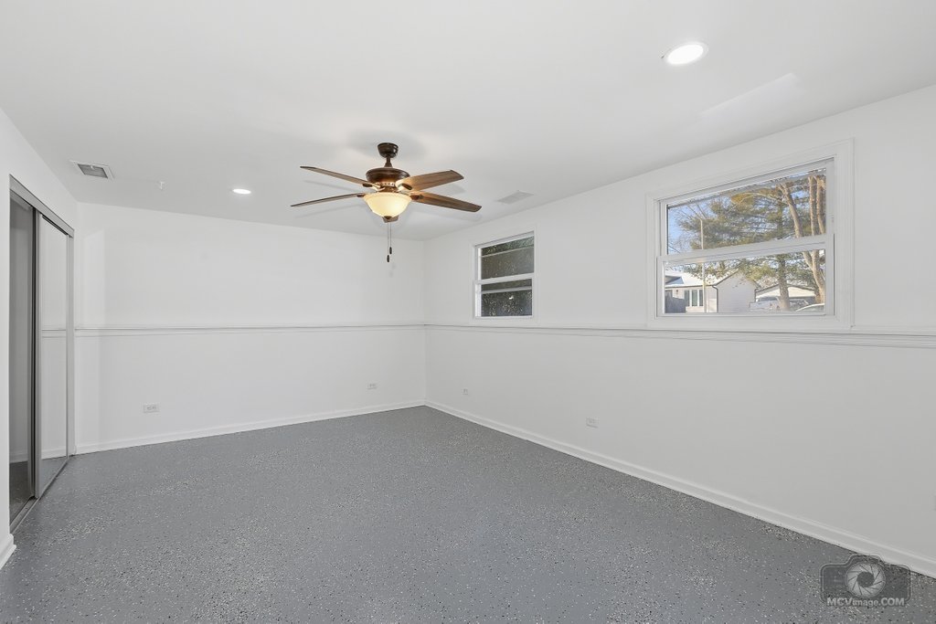 234 Butternut Drive Bolingbrook, IL 60440 - Photo 11 of 17 a view of a livingroom with wooden floor and a ceiling fan