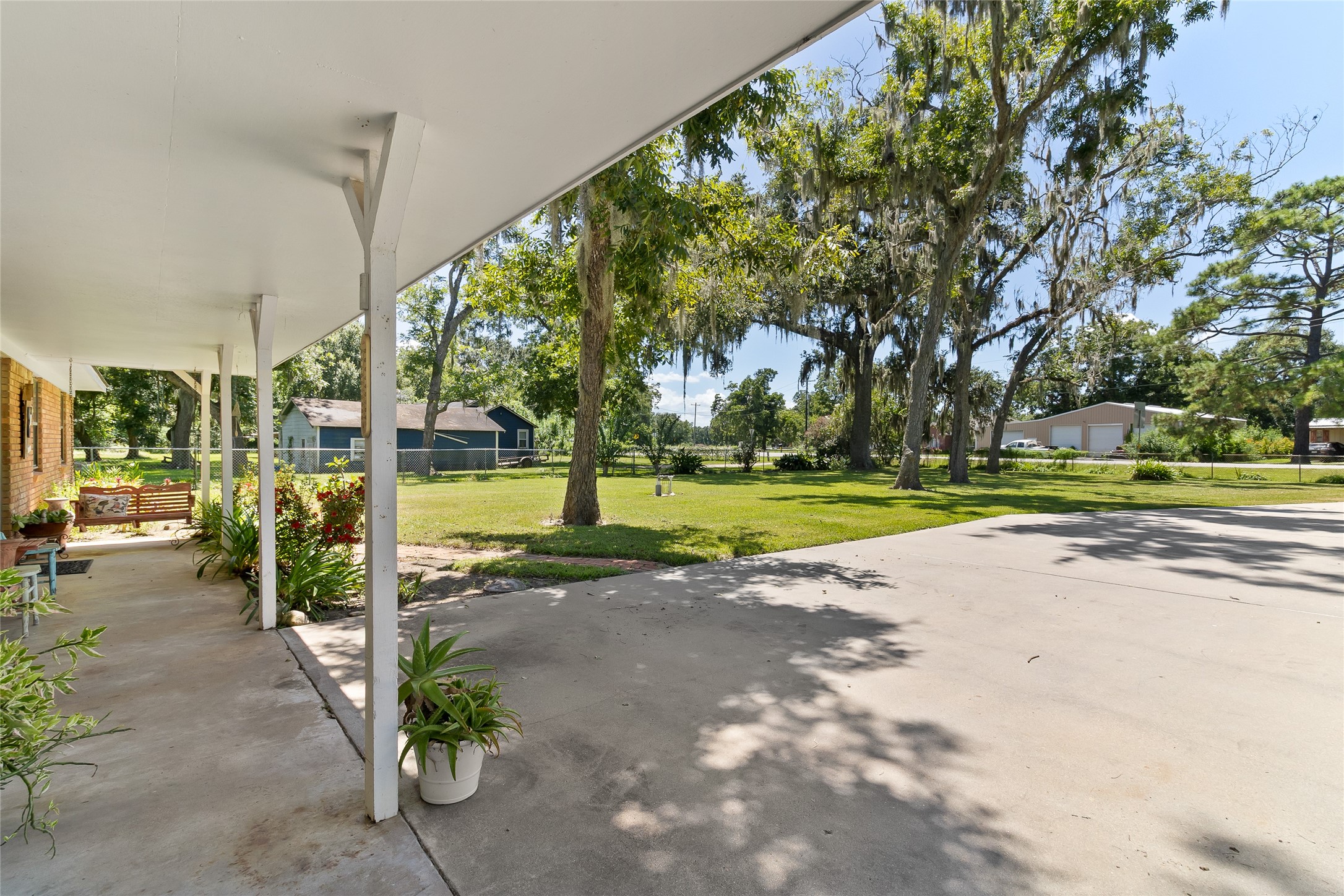 1971 FM 522 Road Brazoria, TX 77422 - Photo 3 of 26 A long concrete driveway adds to the property and acreage appeal, offering plenty of parking and a grand approach to the home.