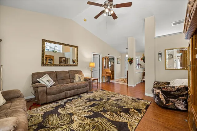 a living room with furniture and a wooden floor