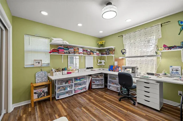 a view of a workspace with furniture and a window