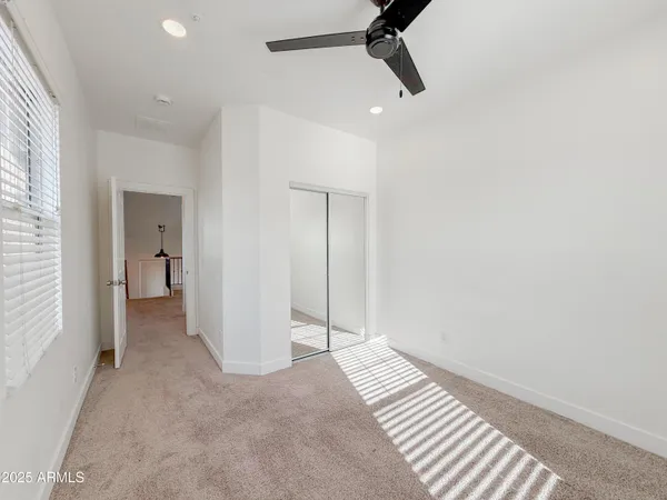 wooden floor in an empty room with a bathroom