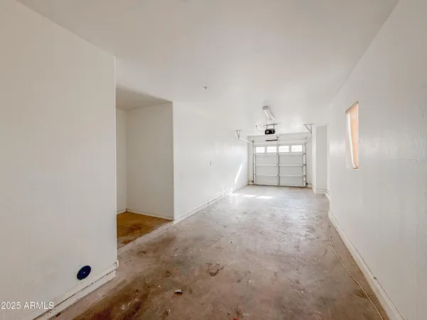 an empty room with a cabinet and a window