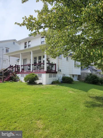 a front view of house with yard and trees