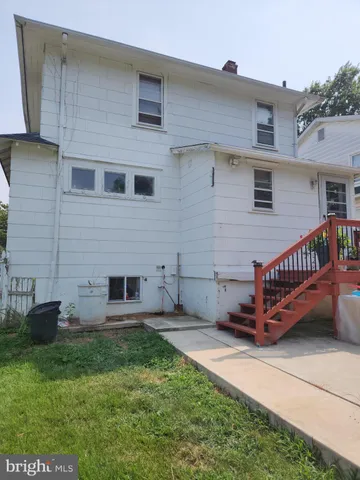 a backyard of a house with a garden and barbeque oven