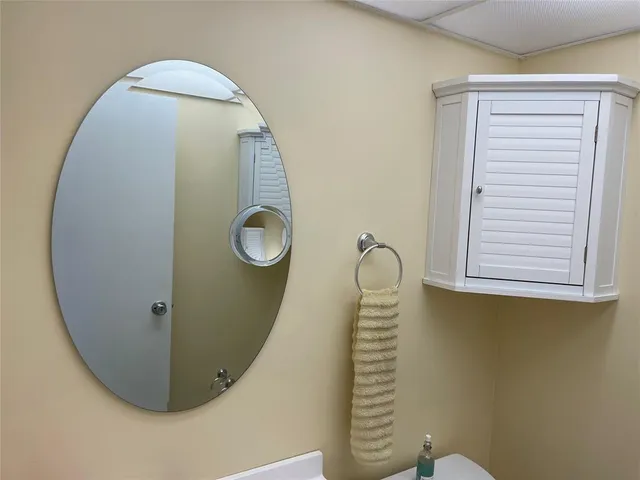 a bathroom with a toilet a sink a vanity and mirror