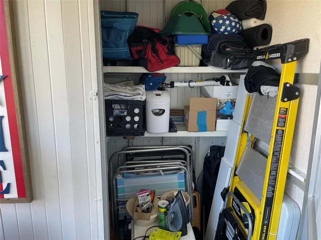 a room with lots of books and baby crib