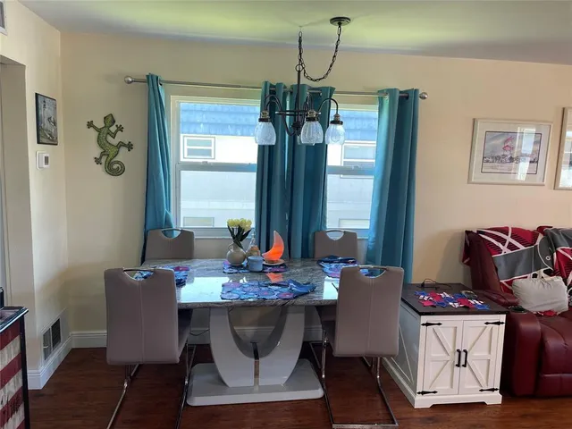 a dining room with furniture and window