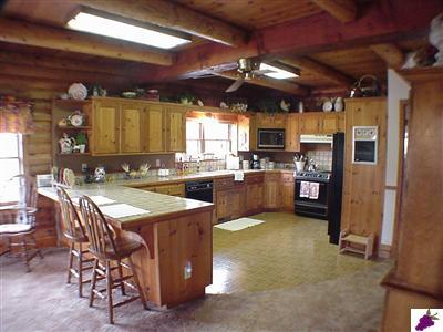 13794 Millerton Road Prather, CA 93651 - Photo 7 of 14 Large kitchen with knotty pine cupboards and breakfast bar