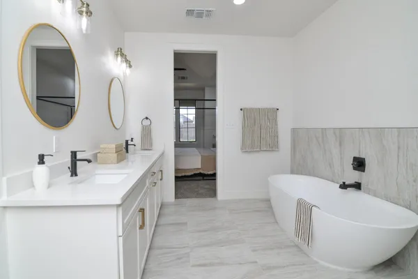 a bathroom with a double vanity sink and a mirror