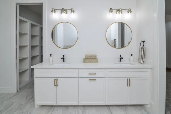 a bathroom with a double vanity sink and a mirror