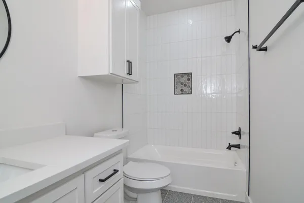 a bathroom with a sink a toilet and a bathtub