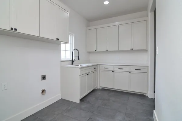 a kitchen with white cabinets and white appliances