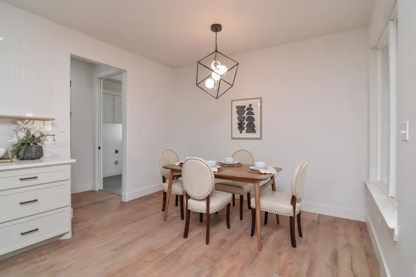 a view of a dining room with furniture and wooden floor