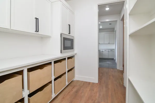 a view of kitchen with sink and wooden floor