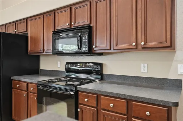 an empty room with a chandelier fan