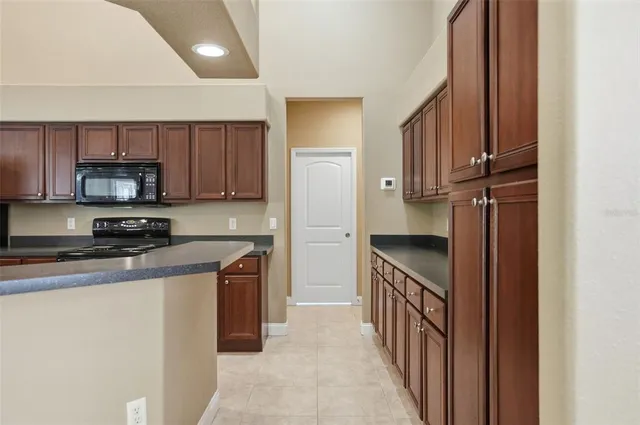 a bedroom with a large bed and a potted plant
