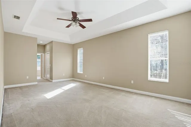 an aerial view of residential houses with outdoor space and trees