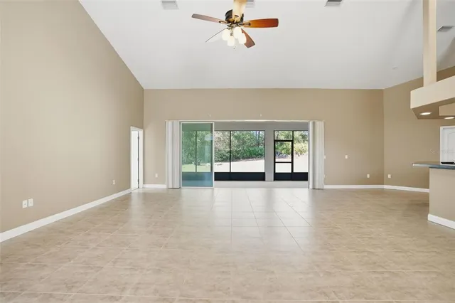 a kitchen with stainless steel appliances granite countertop a stove top oven a sink a refrigerator and a granite counter tops