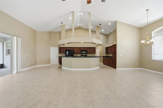 an empty room with a ceiling fan and window