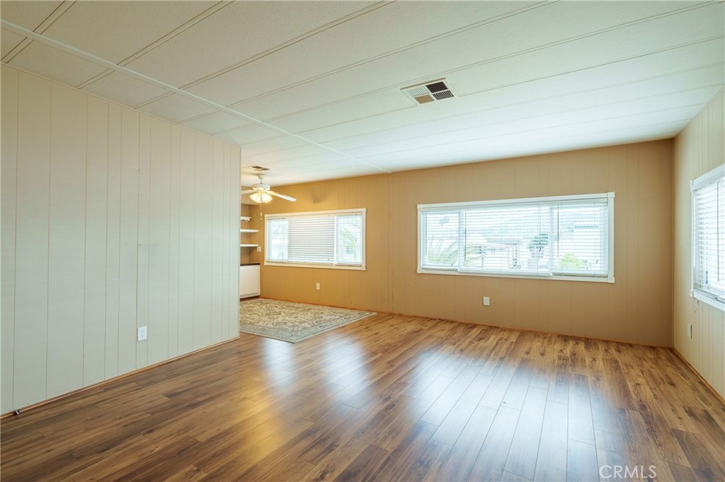 4000 Pierce Street, Unit 72 Riverside, CA 92505 - Photo 6 of 20 an empty room with wooden floor and windows