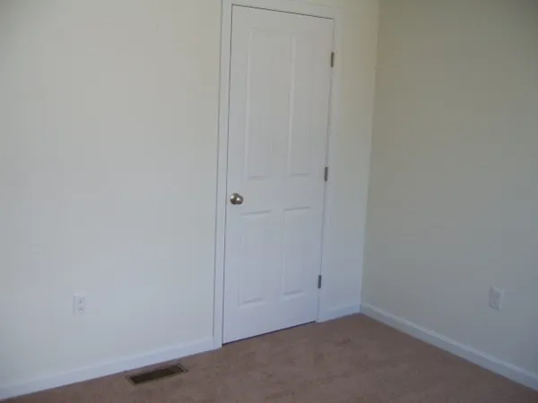 a white toilet sitting in a bathroom next to a window