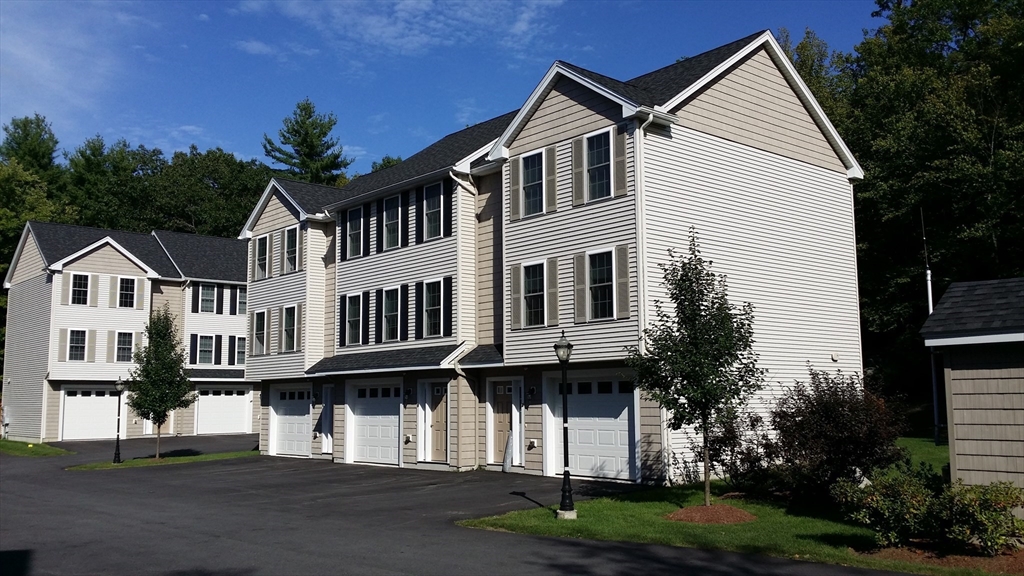 5 Bufton Farm Road, Unit 7 Clinton, MA 01510 - Photo 6 of 22 a view of residential houses with a yard and plants
