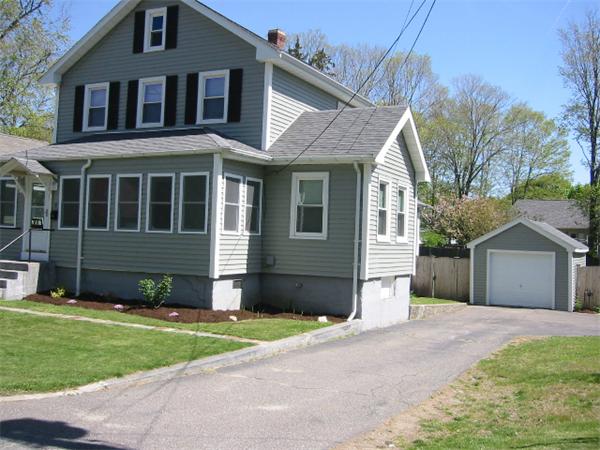 4 Spring Lane Stoneham, MA 02180 - Photo 2 of 13 a front view of a house with a yard