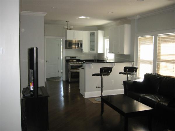 4 Spring Lane Stoneham, MA 02180 - Photo 3 of 13 a kitchen with stainless steel appliances granite countertop a stove a refrigerator a sink a stove and island