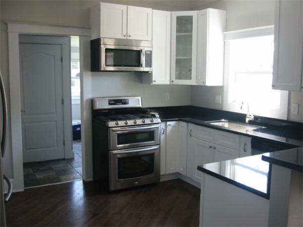 4 Spring Lane Stoneham, MA 02180 - Photo 4 of 13 a kitchen with granite countertop a sink and a stove top oven