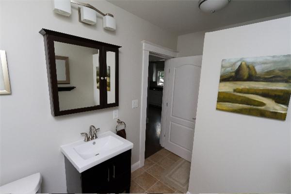 4 Spring Lane Stoneham, MA 02180 - Photo 8 of 13 a bathroom with a toilet sink and mirror