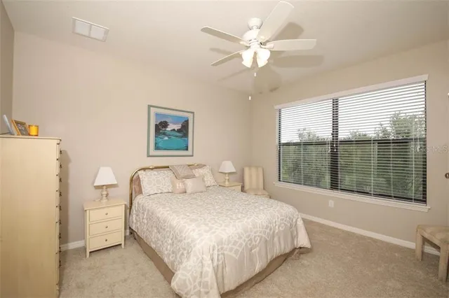 a spacious bedroom with a bed and a large window