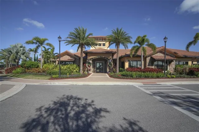 front view of house with a yard and palm trees