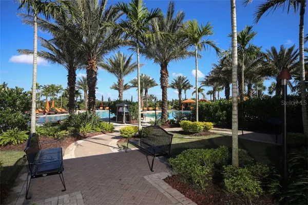 a view of a patio with couches table and chairs potted plants and palm tree