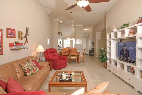 a living room with furniture a chandelier and a fireplace