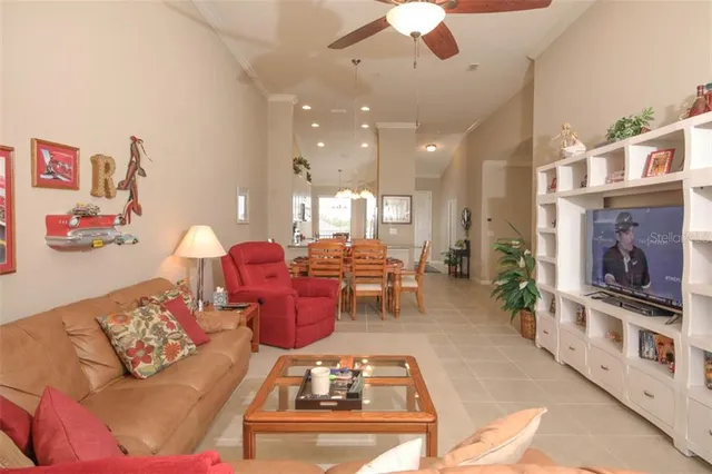 a living room with furniture a chandelier and a fireplace
