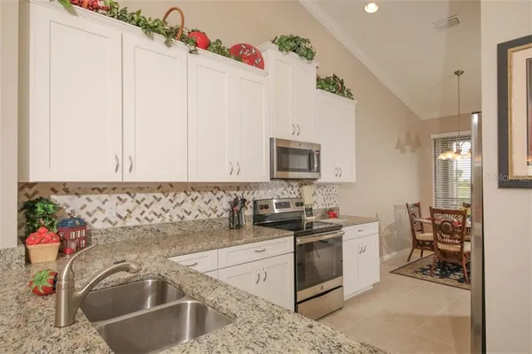 a kitchen with a sink stove and cabinets