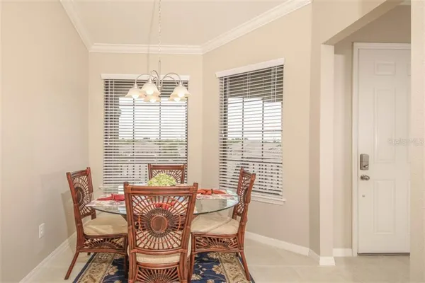 a view of a dining room with furniture and windows