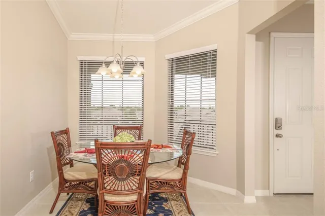 a view of a dining room with furniture and windows
