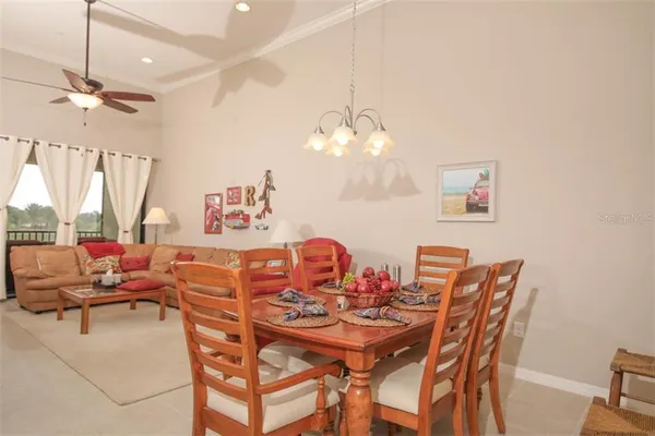 a view of a dining room with furniture and a chandelier