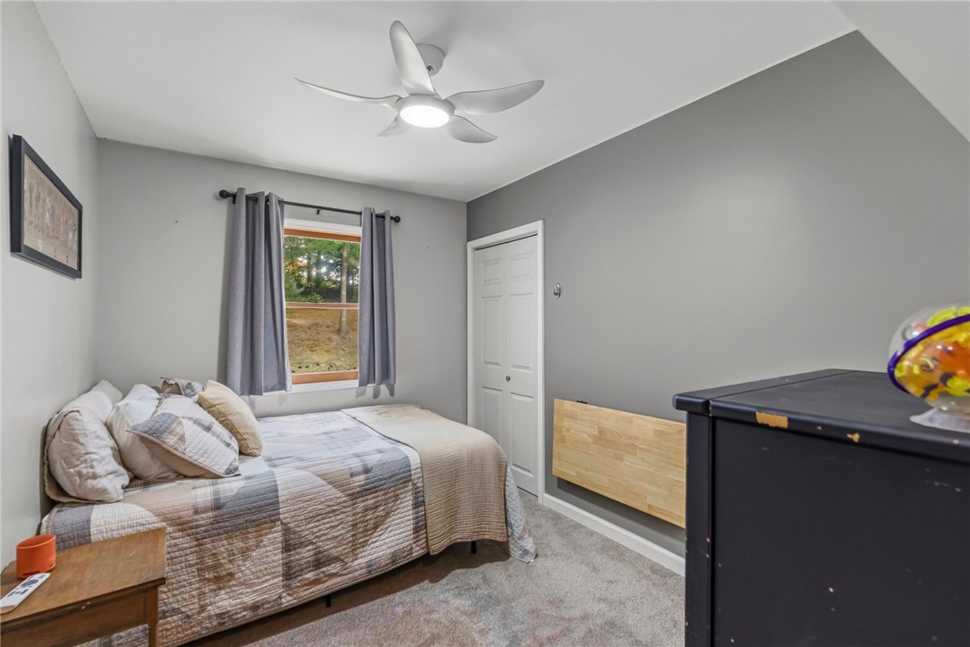 641 Lands End Road Seneca, SC 29678 - Photo 14 of 39 Well-lit sleeping quarters with a ceiling fan, plush carpeting, and a window offering natural light.