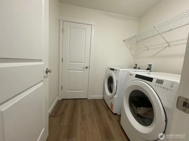 a view of a storage & utility room with dryer and washer